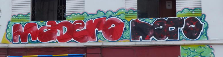 Sign with graffitti-style lettering “Madero Rojo” (red wood)
