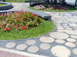 flowers and cobblestone / circular stones near fountain