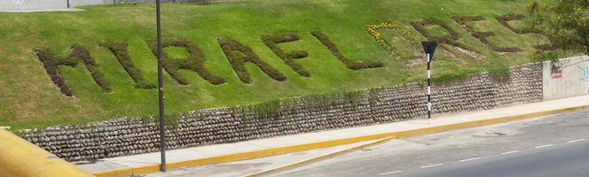 “Miraflores” spelled out in plants on hillside near freeway