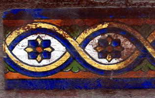 worn mosaic on side of a stairstep