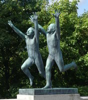 Two children laughing and running, arms above heads