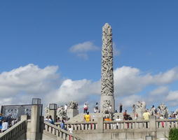 Obelisk with carving of people climbing it