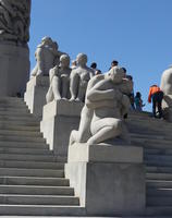 Sculptures of people next to staircase