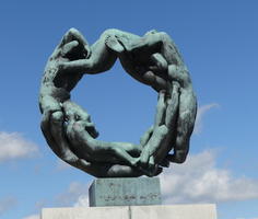 Intertwined human figures forming ring