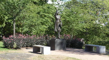 Woman with arm upraised; pedestal reads MÄRTHA