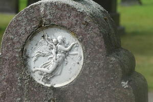 Carving of angel with cherub on her back