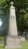 Obelisk-shaped headstone with cross at top