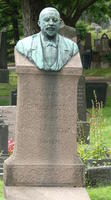 Headstone with bronze bust of man with goatee