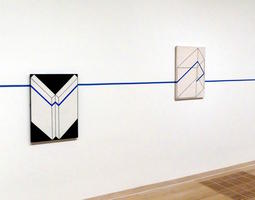 line on wall intersecting paintings