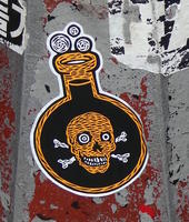 sticker: skull and crossbones on a beaker with bubbling liquid