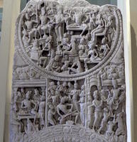 Carving with multiple figures in circular area at top