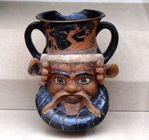 Double-handled drinking cup in shape of man’s head