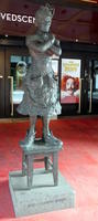 Statue of actress tanding on a four-legged stool