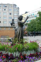 Statue of actress in a ring of live flowers