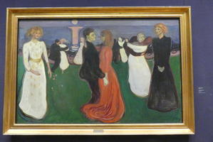 People dancing; man in suit and woman in long red dress in center