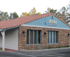 Exterior view of Zen Center, labeled in white on blue-painted roof front