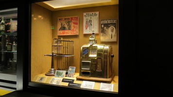 Display case showing old-style gambling equipment (including slot machine)
