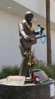 Statue of Elvis Presley, draped with leis
