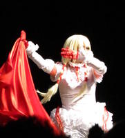 Person in white costume with red cape