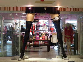 Entrance to women's lingerie shop in form of large legs with stockings and garter.