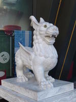 White dragon-like statue with yellow eyes