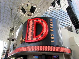 Large neon D with wave-like moving LED display inside the letter