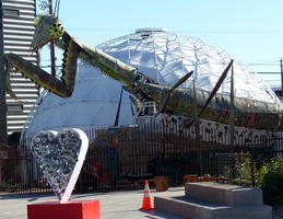 Heart sculpture, giant mantis, and dome in background.