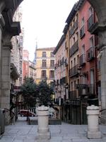 Street of old buildings photographed through archway in Plaza Mayor