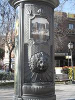 Advertising kiosk with head of a lion in relief