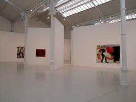Interior René Daniëls exhibit; sparsely scatterd paintings on white walls and white floor.