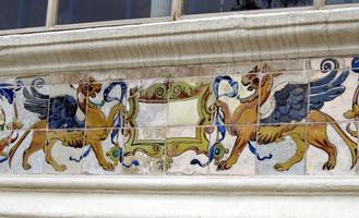 Tilework of gold gryphons with blue wings