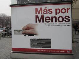Signage, with closeup of hand holding Metro ticket.