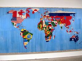 Tapestry map of the world with each country shown by part of its flag