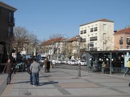 City street scene; bus stop on right