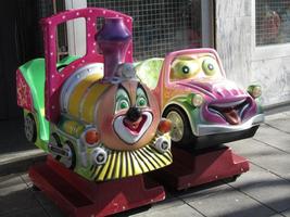 Children's rides bearing minor resemblance to Thomas the Tank Engine and a character from Cars