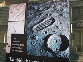 Sign showing footprints at left and lunar footprint at right. Text: “There are many footprints, but only one is THE FOOTPRINT.”