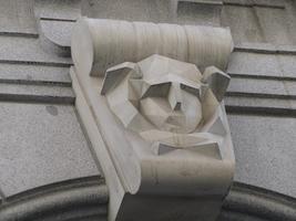 Abstract relief of animal with scrollwork