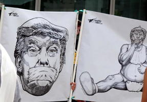 Posters showing DJT with tape over mouth and as a baby