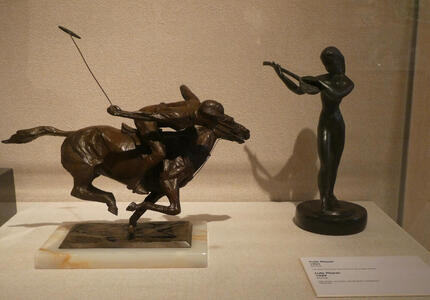 Small sculptures of polo player and female lute player