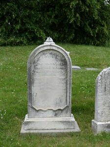 White headstone with faded engraving