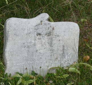 Very small headstone, with engraving totally faded away.