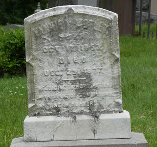 Faded headstone of someone who died in 1877.