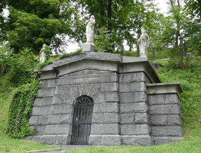Mausoleum with three statues of religious figures on top