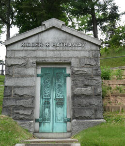 Mausoleum with door showing green patina