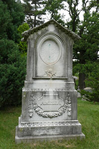 Large grave marker with oval frame at top