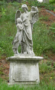 Statue of angel and child looking up at angel