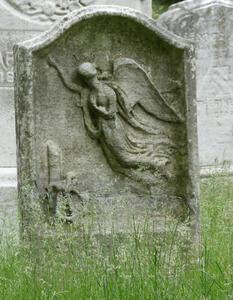 Headstone with relief of angel in flight
