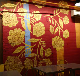 Wall art in style of asian tapestry with yellow flowers on red background