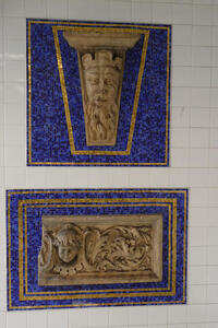 Relief of bearded man on blue and gold mosaic rectangle