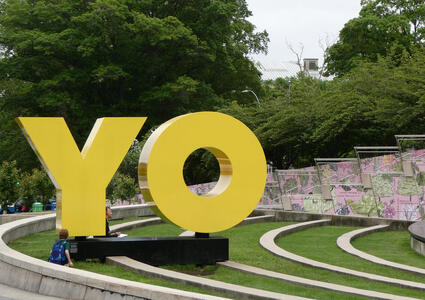 Large yellow sculpture forming word YO